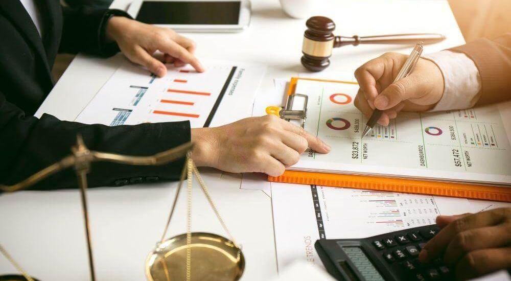People with calculator demonstrating client accounting services for law