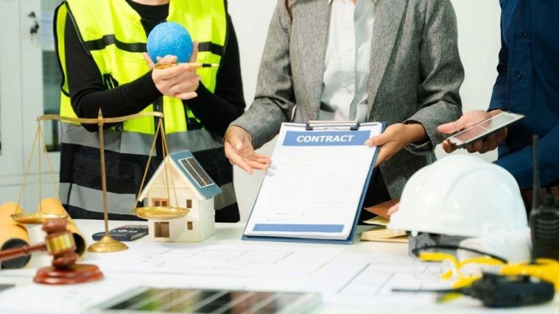 Group of professionals discussing contract management at a table