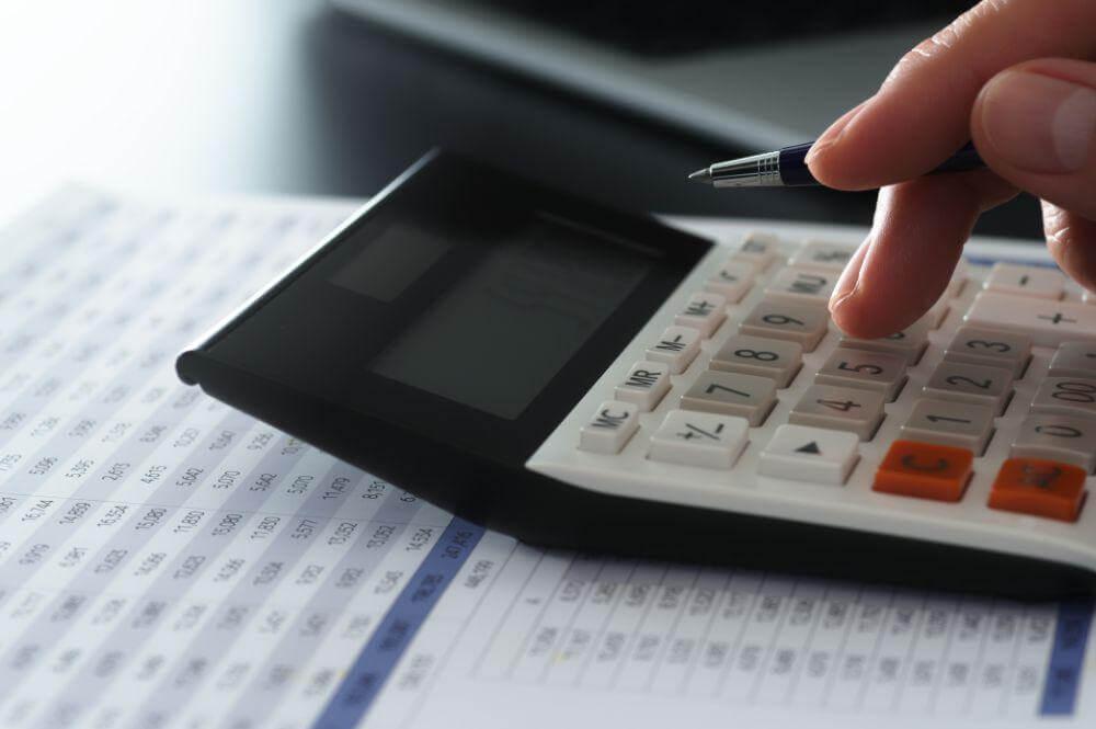 Person calculating costs for submission