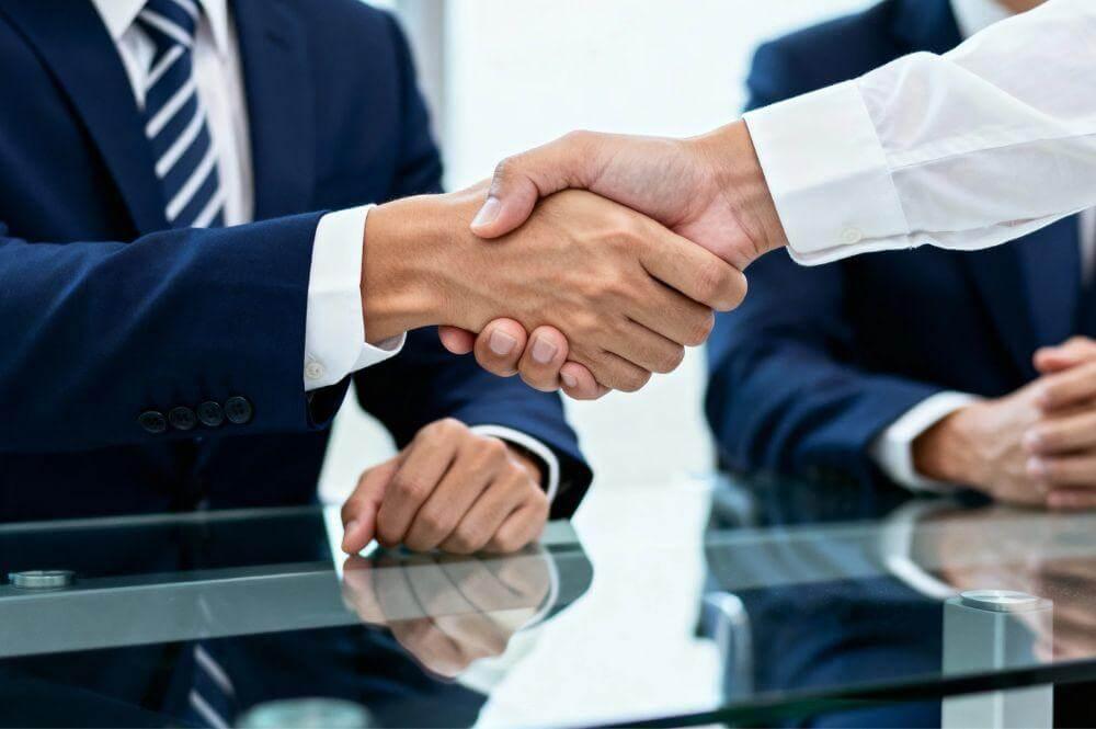 Two men shaking hands, symbolizing a government