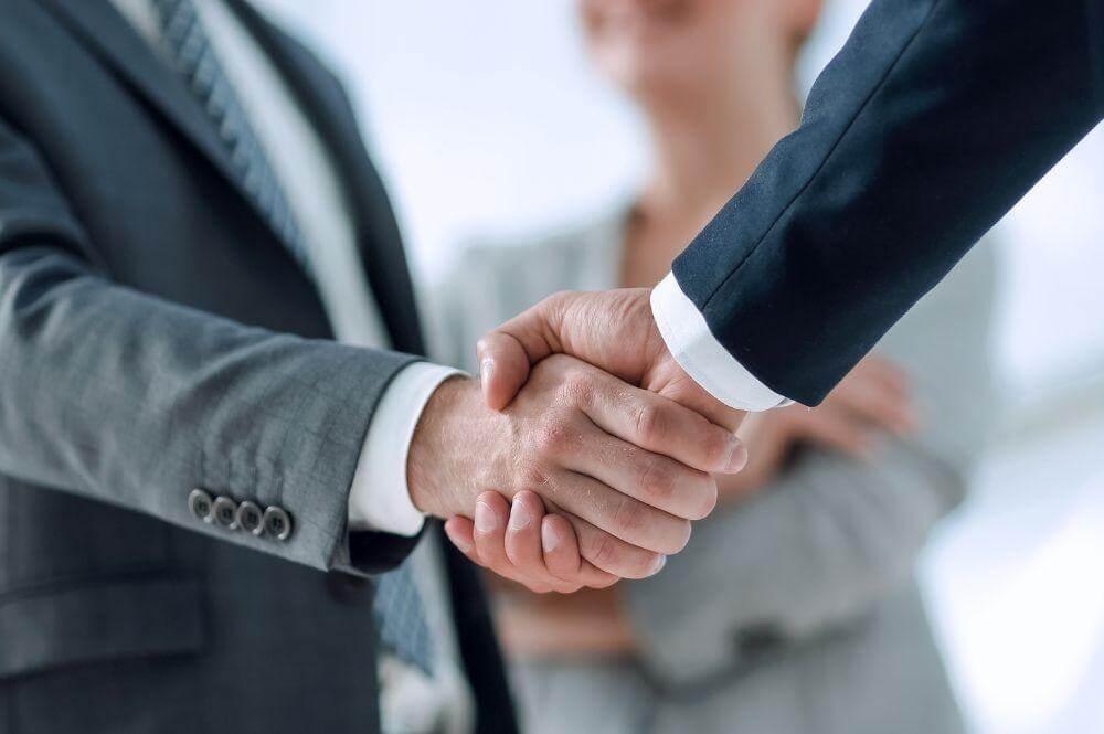 Two people shaking hands, symbolizing a