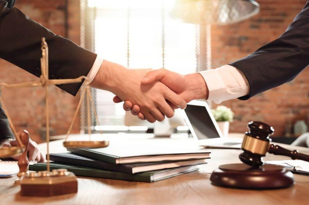 Two people shaking hands, symbolizing the start of