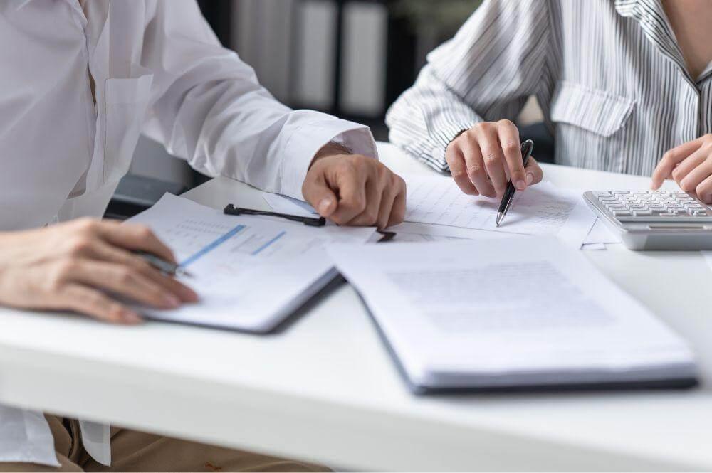 Two people working on DCAA approved accounting